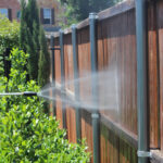 Pressure Washer spraying fence