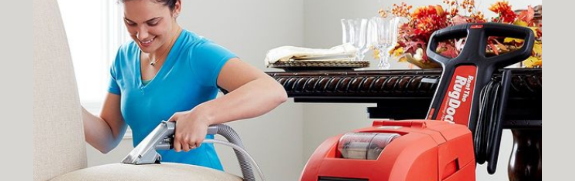 Woman cleaning a white sofa using the RugDoctor Pro hand tool